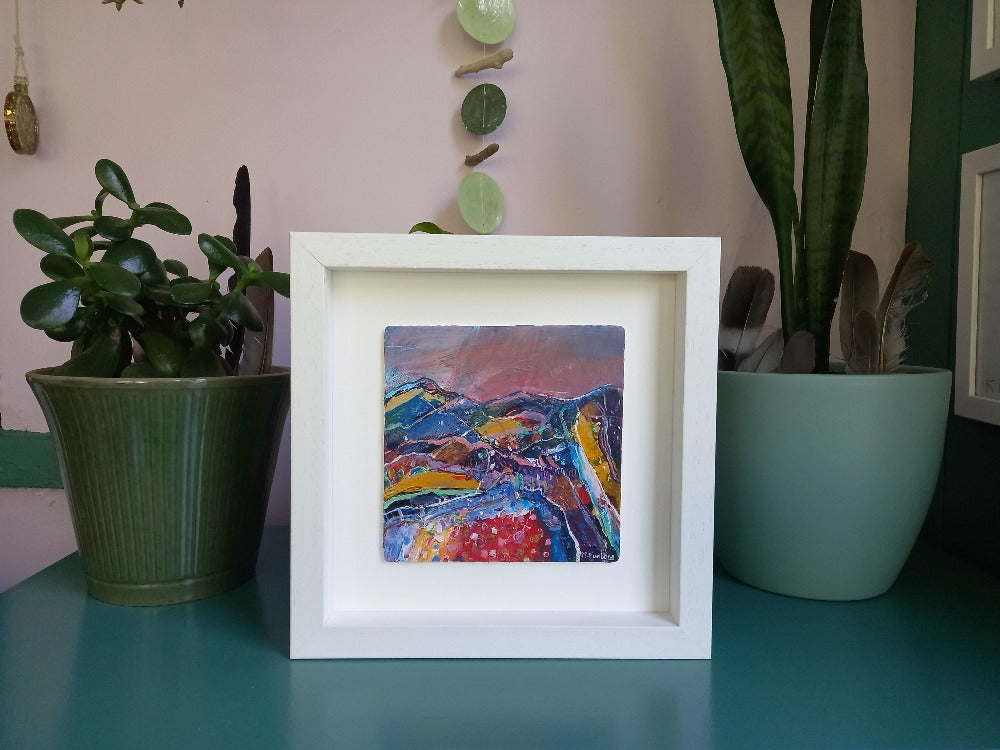 Framed Colourful landscape painting with mountains and fields by Irish artist Martina Furlong