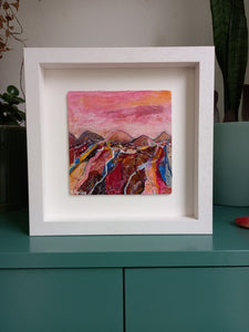 Painting of mountains and fields in red pink brown yellow and blue by contemporary artist Martina Furlong