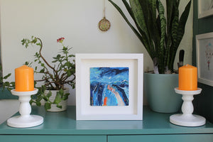 Framed art in situ Expressionist abstract landscape painting in blue and orange by Irish Artist Martina Furlong