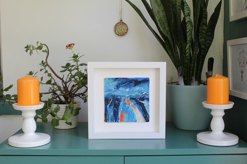 Framed art in situ Expressionist abstract landscape painting in blue and orange by Irish Artist Martina Furlong